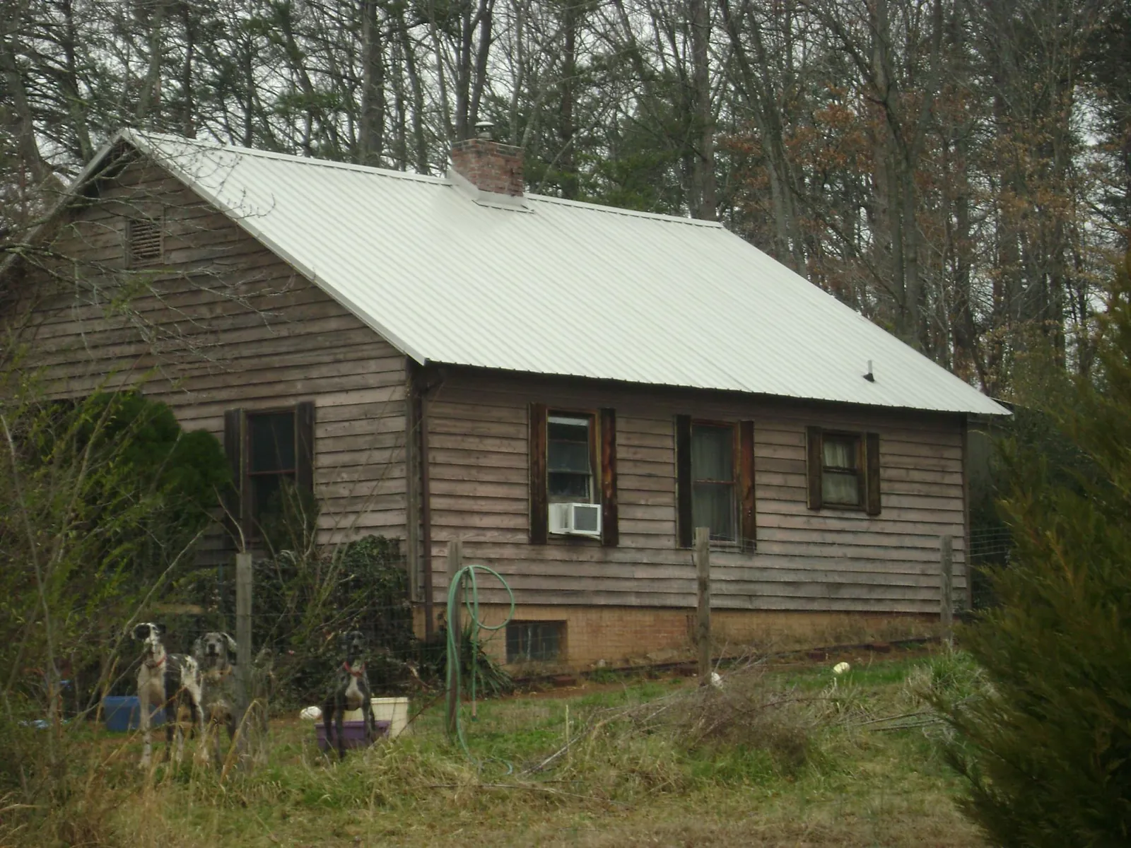 White metal roof on an old wood sided farmhouse, from a Metal Roof Installation job in Gonzales
